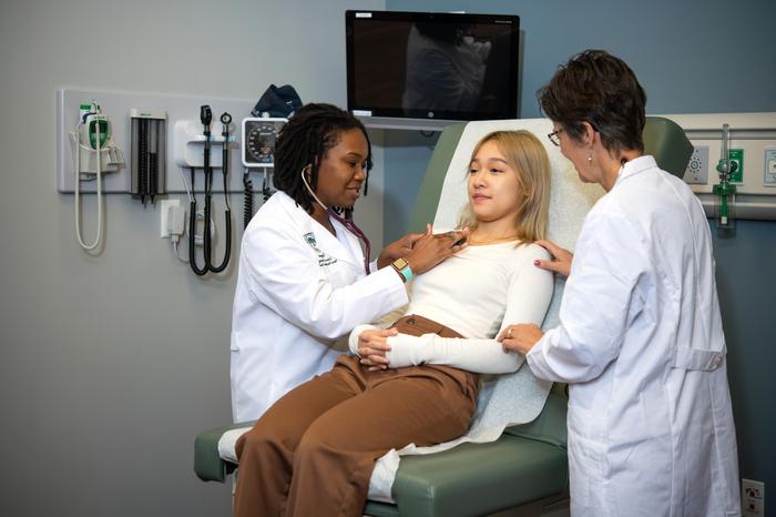 Nursing students taking care of a patient.